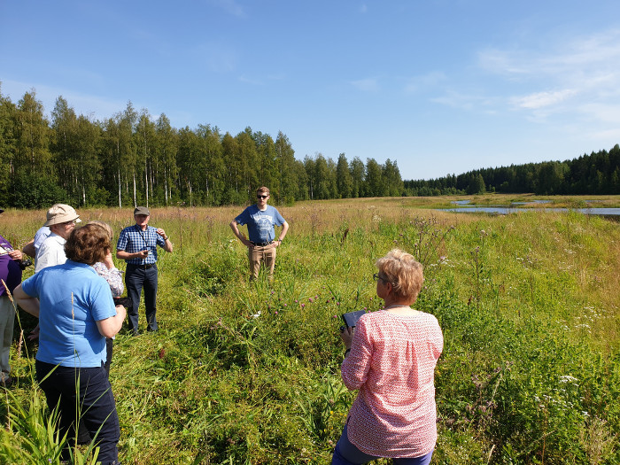 Seppo Ollikainen esittelee Lessinpuron kosteikkoa seminaariyleisölle